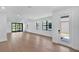 Open-concept living area with hardwood flooring, modern lighting and doors to the exterior at 18803 Dayspring Pl, Venice, FL 34293