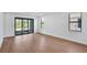 Living room area featuring hardwood flooring, recessed lighting, and a sliding glass door leading to the backyard at 18803 Dayspring Pl, Venice, FL 34293