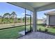 Screened patio with beautiful brick floors overlooking a lush green lawn and nature at 18803 Dayspring Pl, Venice, FL 34293