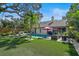 A backyard featuring a pool, dining set, grill, and lounge chairs, perfect for outdoor relaxation and entertaining at 1939 Baywood Pl, Sarasota, FL 34231