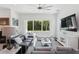 Stylish living room featuring a large window overlooking a pool and modern furnishings at 2220 Pine Ter, Sarasota, FL 34231