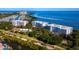 Beautiful waterfront condo buildings with lush landscaping and stunning bay views at 2410 Harbourside Dr # 121, Longboat Key, FL 34228