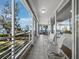 Relaxing balcony with seating area and views of the water and manicured lawn at 2410 Harbourside Dr # 121, Longboat Key, FL 34228