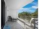 Tiled balcony offers outdoor seating with views of trees and blue skies at 2410 Harbourside Dr # 121, Longboat Key, FL 34228