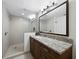 Modern bathroom features a glass-enclosed shower, a granite countertop, and vanity with drawers at 2410 Harbourside Dr # 121, Longboat Key, FL 34228