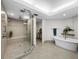 This bright bathroom features a large glass shower, soaking tub, and decorative finishes at 2410 Harbourside Dr # 121, Longboat Key, FL 34228