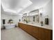 This bright bathroom includes a soaking tub, double vanity, storage, and modern sconces at 2410 Harbourside Dr # 121, Longboat Key, FL 34228