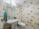 Charming powder room with designer wallpaper, pedestal sink, and modern fixtures at 2410 Harbourside Dr # 121, Longboat Key, FL 34228
