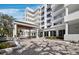 Beautiful condominium building with a covered entrance for easy drop-off on a sunny day at 2410 Harbourside Dr # 121, Longboat Key, FL 34228