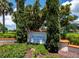 The Longboat Key Club Moorings Marina Village sign surrounded by verdant foliage and manicured shrubs at 2410 Harbourside Dr # 121, Longboat Key, FL 34228