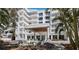A modern building with a covered entrance and tranquil water feature at 2410 Harbourside Dr # 121, Longboat Key, FL 34228