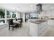 Bright, white kitchen with stainless steel appliances and an island cooktop at 2410 Harbourside Dr # 121, Longboat Key, FL 34228