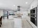 Bright, white kitchen with stainless steel appliances, an island cooktop, and sleek countertops at 2410 Harbourside Dr # 121, Longboat Key, FL 34228