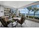 Relaxing lanai with seating area offering beautiful views of the bay and lush greenery at 2410 Harbourside Dr # 121, Longboat Key, FL 34228