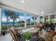 The wide, open lanai includes dining and lounge seating, and a water view at 2410 Harbourside Dr # 121, Longboat Key, FL 34228
