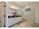 A modern bathroom with a double sink vanity, large mirror, and walk-in shower with glass door at 26833 Weiskopf Dr, Englewood, FL 34223