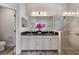 Bright bathroom featuring a double vanity with a granite countertop and a tiled walk-in shower at 26833 Weiskopf Dr, Englewood, FL 34223