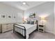 Comfortable bedroom featuring a metal frame bed and coordinated bedside tables at 26833 Weiskopf Dr, Englewood, FL 34223
