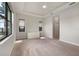A large bedroom with carpet flooring and natural light from windows and minimalist decor at 26833 Weiskopf Dr, Englewood, FL 34223