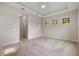 A large bedroom with an attached bathroom and carpet flooring and natural light from windows at 26833 Weiskopf Dr, Englewood, FL 34223