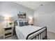Cozy bedroom with a metal frame bed, neutral walls, and soft carpeting at 26833 Weiskopf Dr, Englewood, FL 34223