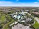 Aerial view of a resort-style community pool and bar surrounded by palm trees and houses at 26833 Weiskopf Dr, Englewood, FL 34223