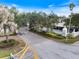 Boca Royale entrance with stone gate posts, mature landscaping and paved road under blue sky at 26833 Weiskopf Dr, Englewood, FL 34223