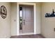 Elegant front door with sidelight, decorative metal art, and a welcoming entrance at 26833 Weiskopf Dr, Englewood, FL 34223