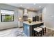 This spacious kitchen boasts a large island with bar seating, white cabinets and modern appliances at 26833 Weiskopf Dr, Englewood, FL 34223