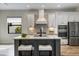 Modern kitchen with white cabinetry, a large island with seating, and stainless steel appliances at 26833 Weiskopf Dr, Englewood, FL 34223