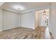 Bright, open-concept living space with wood-look tile flooring and a view of the front door at 26833 Weiskopf Dr, Englewood, FL 34223