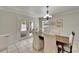 Bright dining room features wood table, white chairs, and door to outside at 2913 Williamsburg St, Sarasota, FL 34231