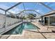 Relaxing screened-in pool area with ample seating and a clear blue pool at 2913 Williamsburg St, Sarasota, FL 34231