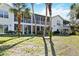 Backyard view of screened lanais on a bright, sunny day at 306 Lynbrook Cir # 201, Venice, FL 34292
