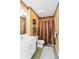Cozy bathroom with warm lighting, striped shower curtain, and practical layout at 306 Lynbrook Cir # 201, Venice, FL 34292