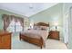 Inviting bedroom featuring a wooden bed frame, side tables, and neutral tones, creating a cozy and relaxing atmosphere at 306 Lynbrook Cir # 201, Venice, FL 34292
