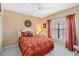 Comfortable bedroom with a queen-size bed, soft lighting, and red-toned decor at 306 Lynbrook Cir # 201, Venice, FL 34292