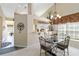 Cozy dining area with a glass table, elegant chandelier, and view of the kitchen bar at 306 Lynbrook Cir # 201, Venice, FL 34292