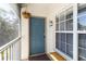 Charming entryway boasts a blue door and a hanging flower basket at 306 Lynbrook Cir # 201, Venice, FL 34292