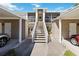 Exterior showcasing stairs and carport access to the condo units at 306 Lynbrook Cir # 201, Venice, FL 34292