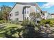 Well-maintained exterior with mature landscaping and manicured lawn at 306 Lynbrook Cir # 201, Venice, FL 34292