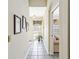 Hallway featuring tile floors and access to the living area at 306 Lynbrook Cir # 201, Venice, FL 34292