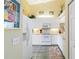 Bright kitchen with white cabinetry, modern appliances, and neutral countertops at 306 Lynbrook Cir # 201, Venice, FL 34292