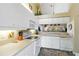 Bright kitchen with white cabinetry, modern appliances, and neutral countertops at 306 Lynbrook Cir # 201, Venice, FL 34292