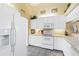 Bright kitchen with white cabinetry, modern appliances, and neutral countertops at 306 Lynbrook Cir # 201, Venice, FL 34292
