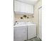 Convenient laundry area features upper cabinets for storage at 306 Lynbrook Cir # 201, Venice, FL 34292