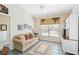 Comfortable living room with tiled floors, sofa, and a built-in entertainment center at 306 Lynbrook Cir # 201, Venice, FL 34292