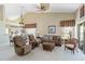 Inviting living room with vaulted ceilings, ceiling fan, comfortable seating, and natural light, perfect for relaxation at 306 Lynbrook Cir # 201, Venice, FL 34292