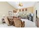 Spacious living room with vaulted ceilings, ceiling fan, comfortable seating, and a serene view of the outdoors at 306 Lynbrook Cir # 201, Venice, FL 34292