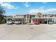 View of the condo building with covered parking spaces at 306 Lynbrook Cir # 201, Venice, FL 34292